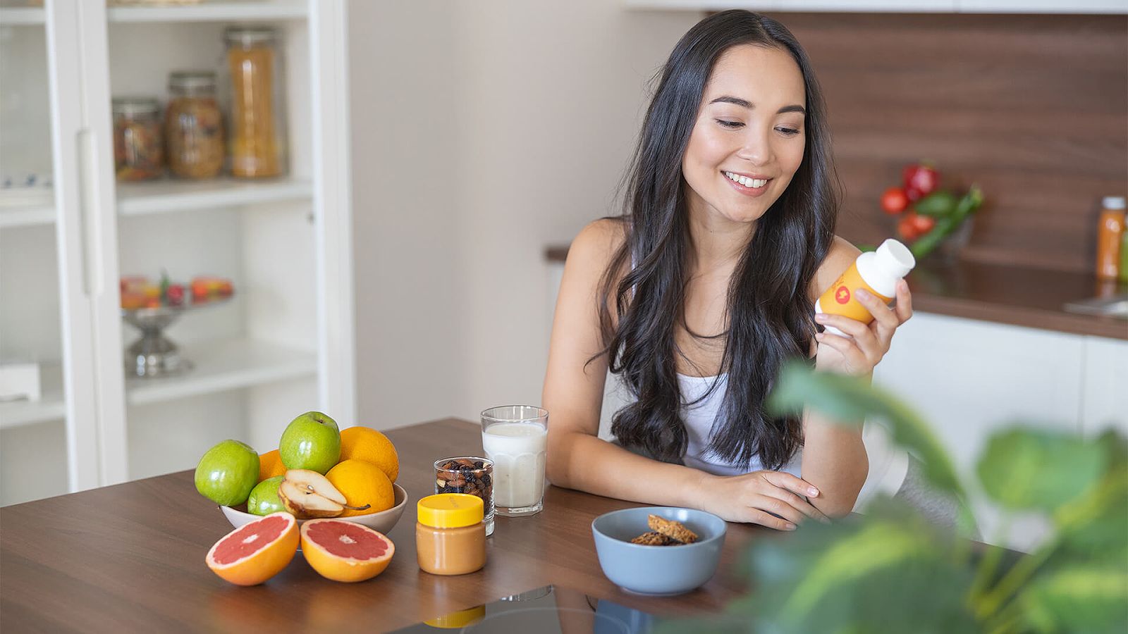 Woman looking at a supplement bottle